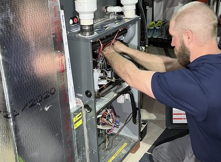 hvac technician working on a heating system