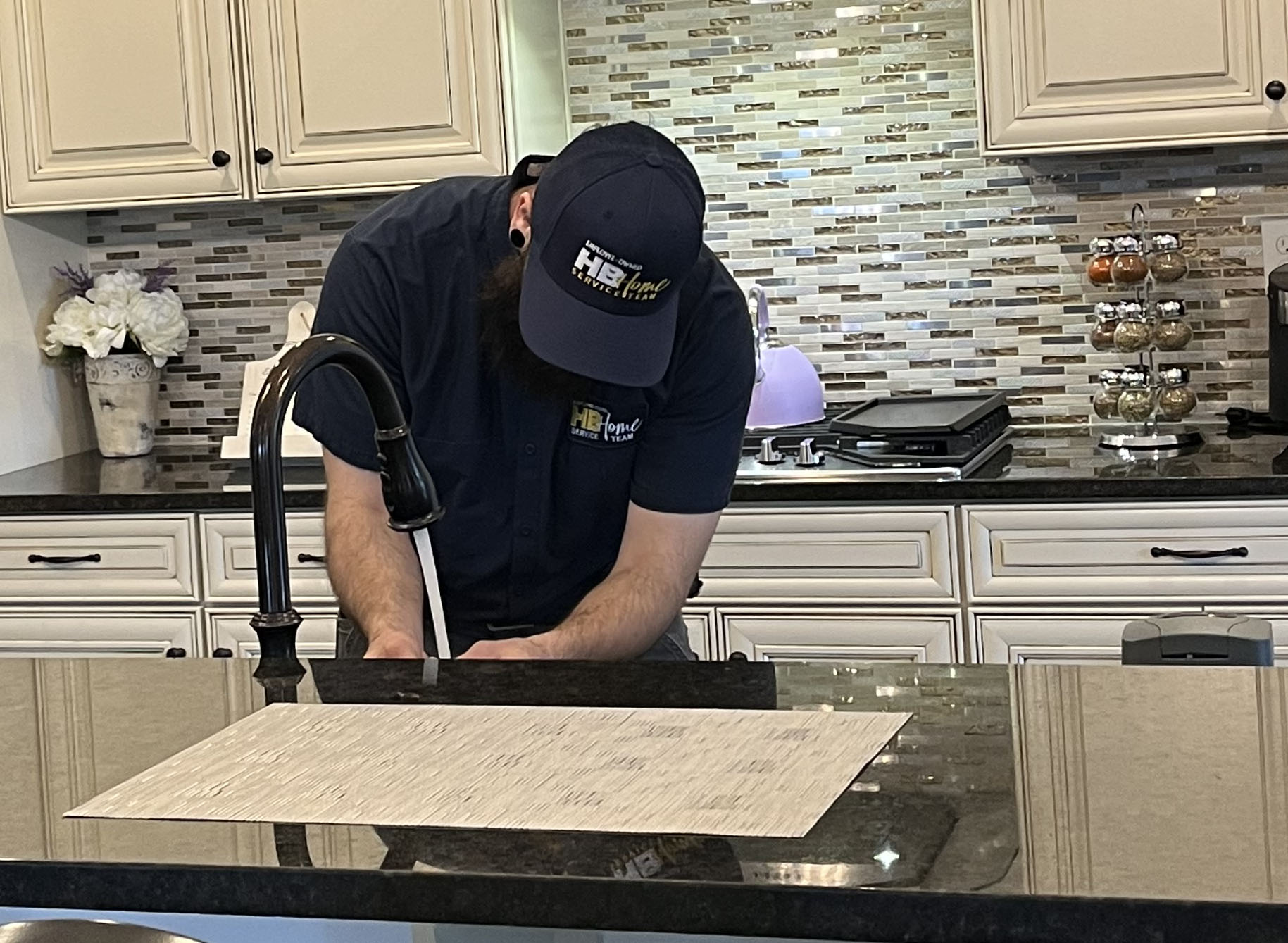 plumber fixing a kitchen faucet