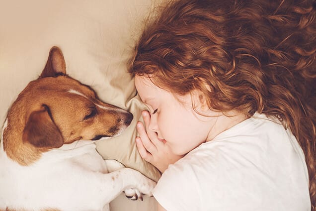 Girl and dog sleeping